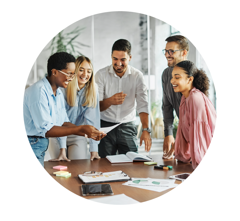 image of professionals collaborating around a table | Higher Ed Marketing & Student Search Services | enrollmentFUEL
