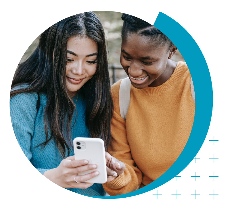 image of female college students looking at a mobile device together | Higher Ed Marketing & Student Search Services | enrollmentFUEL